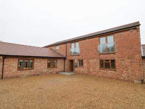 a brick building with a large yard in front of it at 85A Braybrooke Road in Kettering