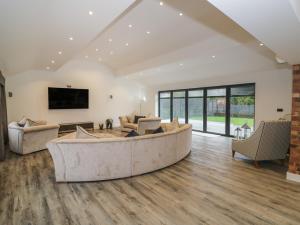 a large living room with a large couch and chairs at 85A Braybrooke Road in Kettering