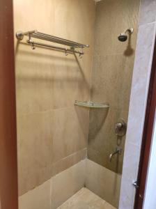 a bathroom with a shower with a glass door at Eternal Wave Apartments by Daystar Ventures in Calangute