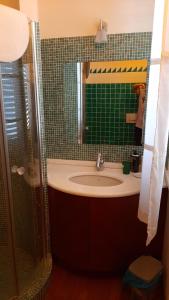 ein Bad mit einem Waschbecken und einem Spiegel in der Unterkunft B & B Paradiso in Loreto