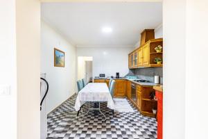 a kitchen with a table in the middle of it at Casa T1 Área Metropolitana do Porto in Carregosa