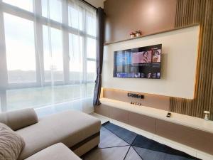a living room with a large window and a flat screen tv at D'Summit Tropika - 2 Rooms 4 Pax, Free Parking in Johor Bahru