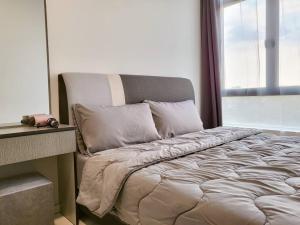 a bed sitting in a room with a window at D'Summit Tropika - 2 Rooms 4 Pax, Free Parking in Johor Bahru +24 photos