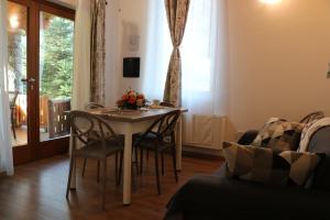 a living room with a table and chairs and a couch at Lazy Bee Camping Village in Aosta