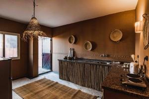 a kitchen with a counter and a large window at Central Majorelle Apartment Sleeps 4 in Marrakesh