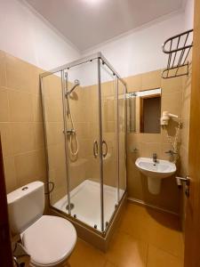 a bathroom with a shower and a toilet and a sink at Бобри плюс in Novovolynsʼk