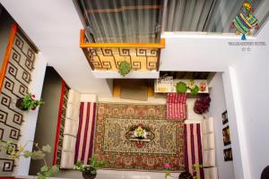 an aerial view of a room with a rug and a balcony at ANDEAN VALLEY HOTEL in Cusco