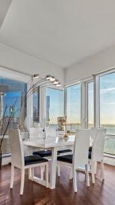 a white dining room with a white table and chairs at Luxurious 4 BR Penthouse in NYC in New York