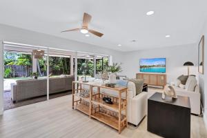 a living room with a couch and a ceiling fan at Luxury Pool & Spa Home near Beaches & Downtown in Fort Myers