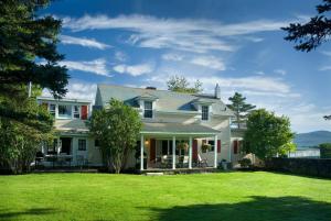 a white house with a large yard at Equinox Resort Residences in Manchester