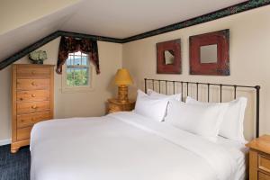 a bedroom with a large white bed and a window at Equinox Resort Residences in Manchester +74 photos