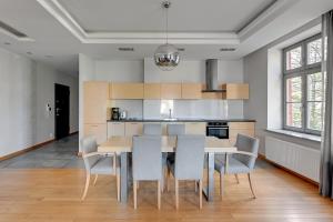 a kitchen and dining room with a table and chairs at Dom & House Apartments - Old Town Tobiasz Residence - Fitness & Parking in Gdańsk