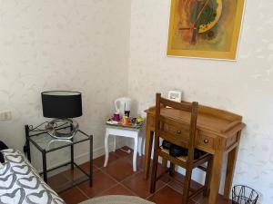 a room with a bed and a desk and a television at La Belle Chaumière in Bretagne-de-Marsan