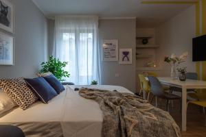 1 dormitorio con 1 cama y 1 mesa con sillas en Ginger-Appartamento a due passi dal centro con posto auto - Porta Romana en Siena