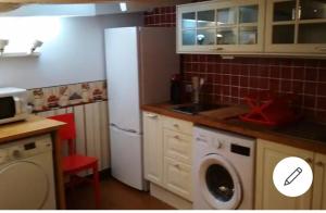 a kitchen with a refrigerator and a washing machine at Loft 1a linea puerto deportivo EBI1286 in Bermeo