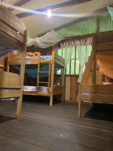 a room with two bunk beds in a tent at YAKU lodge & camping in Padre Cocha
