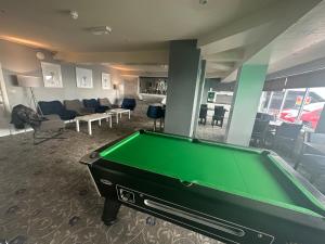 a pool table in a room with a living room at North Ocean Hotel in Blackpool