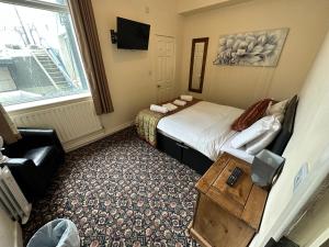 a hotel room with a bed and a window at North Ocean Hotel in Blackpool +63 photos