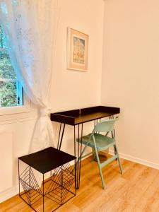 a desk and a chair in a room with a window at Parc de BUC in Buc