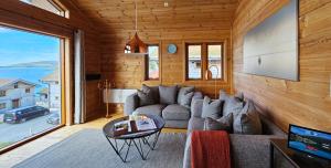 a living room with a couch and a table at Mikkelvik Brygge in Mikkelvika