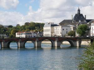 a bridge over a river in a city with buildings at Spicy - Séjour insolite sur la Marne in Meaux