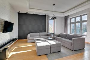 a living room with two couches and a tv at Dom & House Apartments - Old Town Tobiasz Residence - Fitness & Parking in Gdańsk