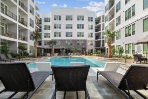 an image of a swimming pool in a apartment building at ELUXE @ Riveroaks in Houston