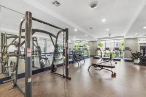 a gym with several treadmills and machines at ELUXE @ Riveroaks in Houston