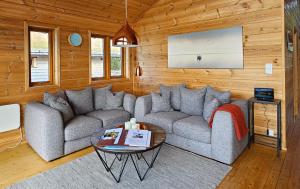 a living room with a couch and a table at Mikkelvik Brygge in Mikkelvika