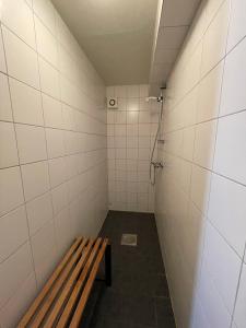 a bathroom with a bench and a shower at Lofoten Budget Hostel in Å