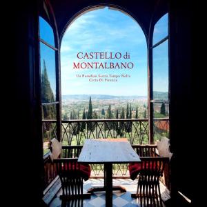 a table in a window with a view of a mountain range at Castello di Montalbano in San Jacopo al Girone
