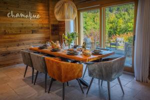 a dining room with a wooden table and chairs at Chalet Chamaline - OVO Network in Le Grand-Bornand