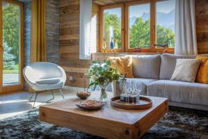 a living room with a couch and a coffee table at Chalet Chamaline - OVO Network in Le Grand-Bornand
