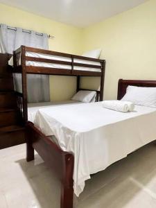a bedroom with a large bed with white sheets at Hotel La Playa in Santa Cruz de Barahona