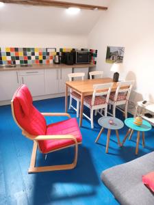 ein Wohnzimmer mit einem Tisch und Stühlen sowie eine Küche in der Unterkunft Gite Meilhards in Meilhards