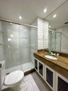 a bathroom with a toilet and a sink and a shower at Apartamento no Porto Real Resort com vista espetacular p/ 6 adultos e 4 adolescentes in Mangaratiba