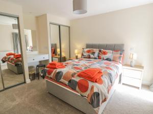 a bedroom with a large bed and a mirror at Buckled Barn in Dumfries