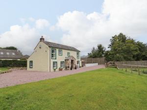 a house with a yard and a fence at Buckled Barn in Dumfries