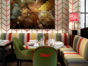 a restaurant with a table and chairs and a painting at Crosby Street Hotel in New York +20 photos