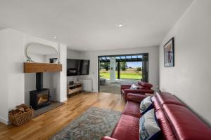 a living room with a couch and a fireplace at Wester Den in Arbroath