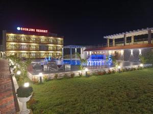 a hotel at night with lights in the yard at Shinjini Resort in Mandarmoni
