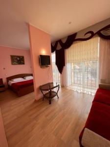 a room with a bedroom with a bed and a television at Бобри плюс in Novovolynsʼk