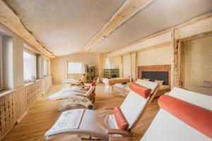 a room filled with lots of chairs and tables at Hotel Hoferwirt in Neustift im Stubaital