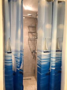 a shower with blue curtains with two boats on it at Beyoğlu/Taksim are also in a perfect location in Istanbul
