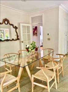 a dining room with a glass table and chairs at Mountain Villa in Dandenong Ranges in Mount Dandenong
