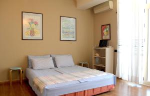 a bedroom with a bed and two stools in it at Albi Guest House in Vlorë