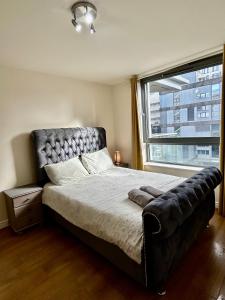 a bedroom with a large bed with a large window at The Cube Side Apartments - One Bedroom With Balcony in Birmingham