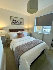 a bedroom with a large bed and a window at Compact Modern Apartment Single Person or Couple Only in Bangor