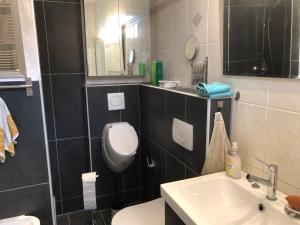 a bathroom with a toilet and a sink at Lioba Drescher Hendel in Berlin +6 photos