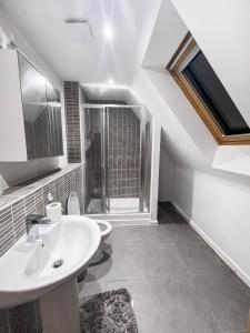 a white bathroom with two sinks and a window at Private Rooms at Oxley Comfy House - Milton Keynes in Broughton